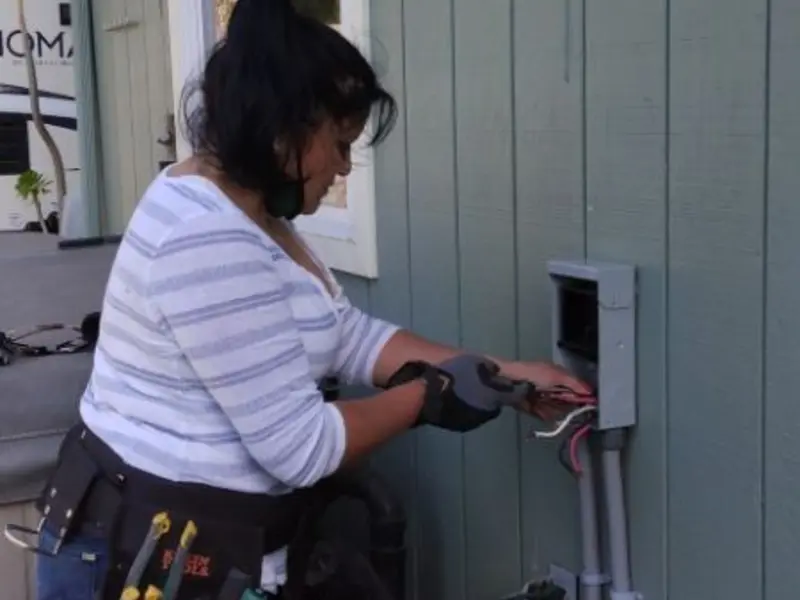 Licensed electrician wiring an exterior subpanel in Orcutt